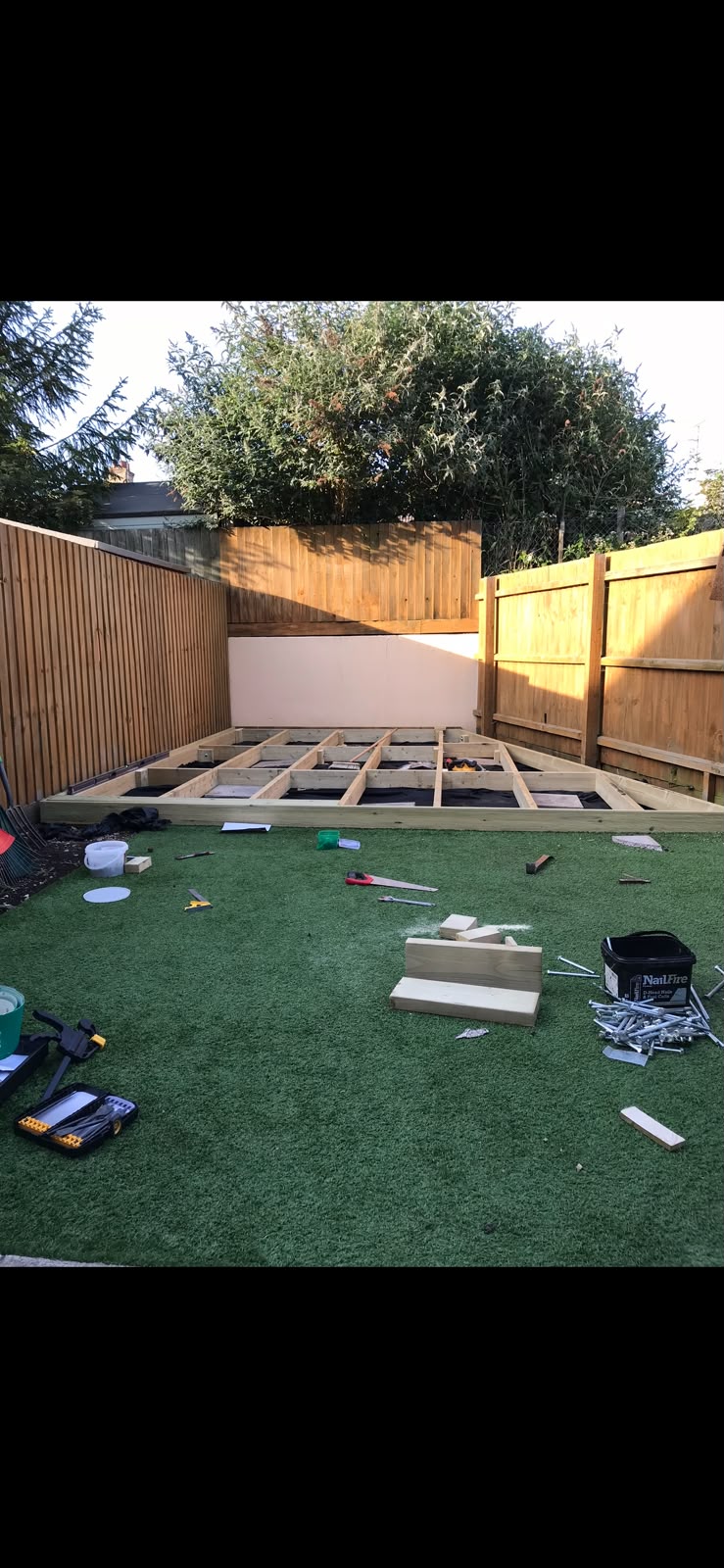 Timber base being constructed to fit a garden corner
