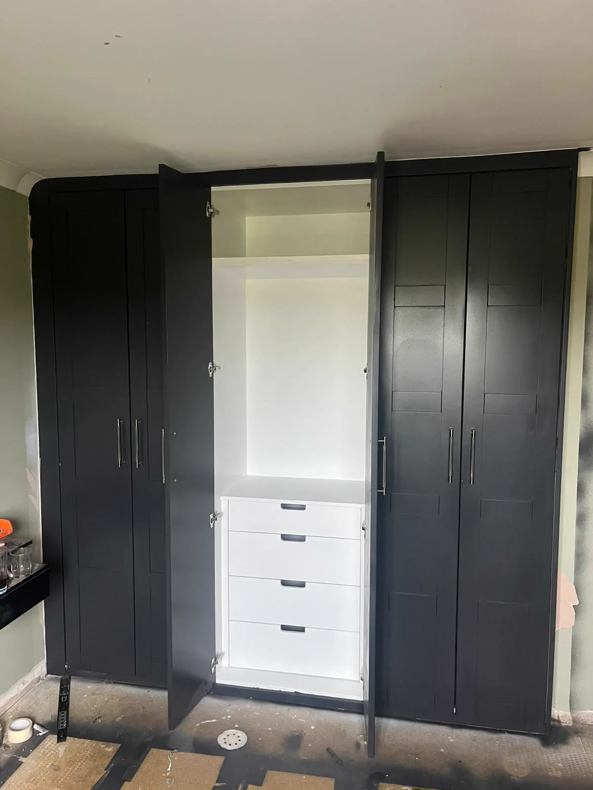 Dark fitted wardrobes with internal drawers