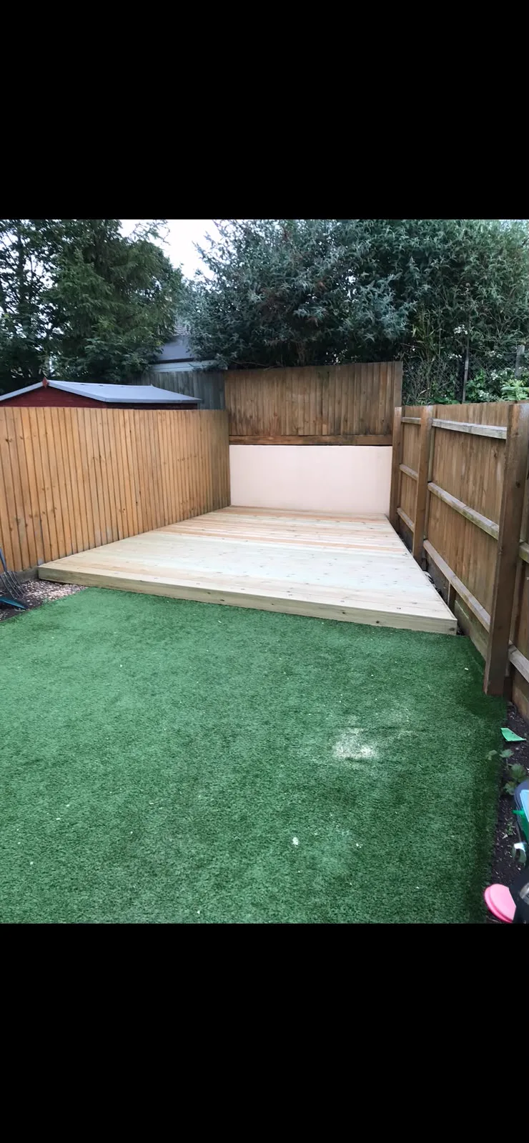 Completed made-to-measure timber platform fitted into the garden corner