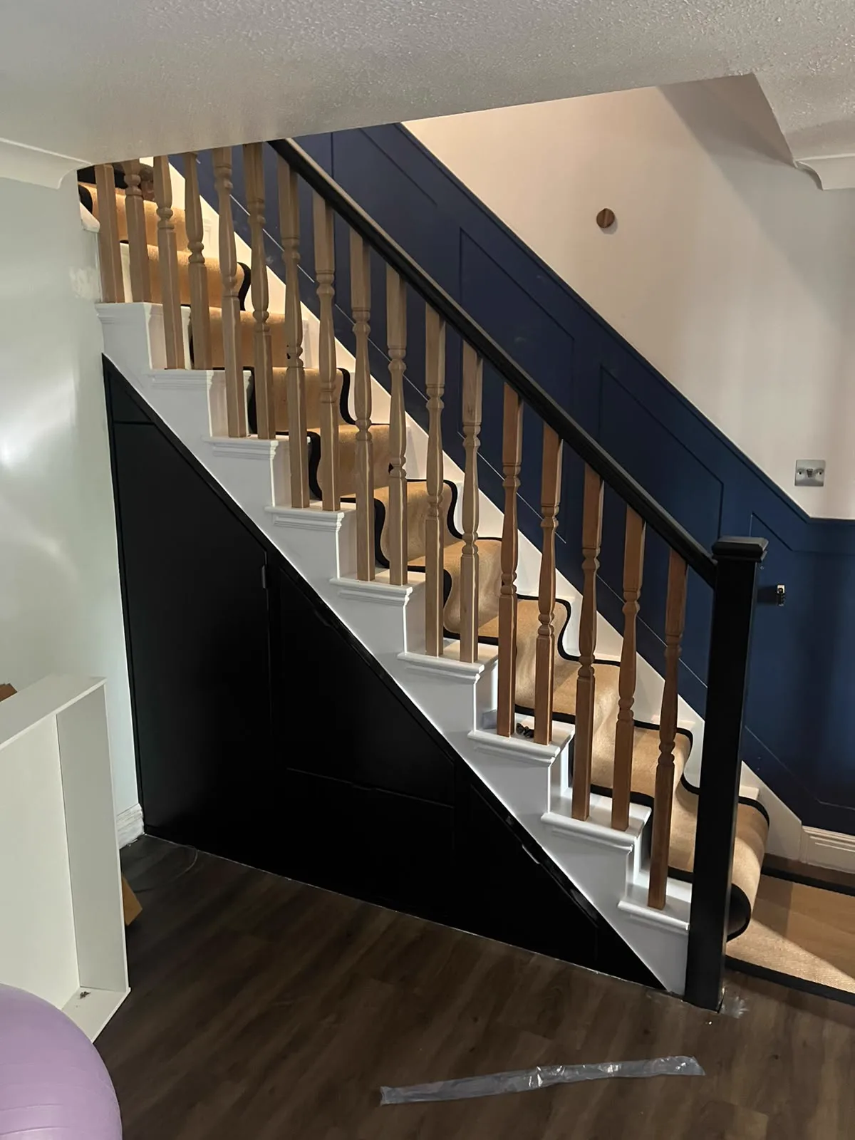 Bespoke cupboards fitted beneath a staircase