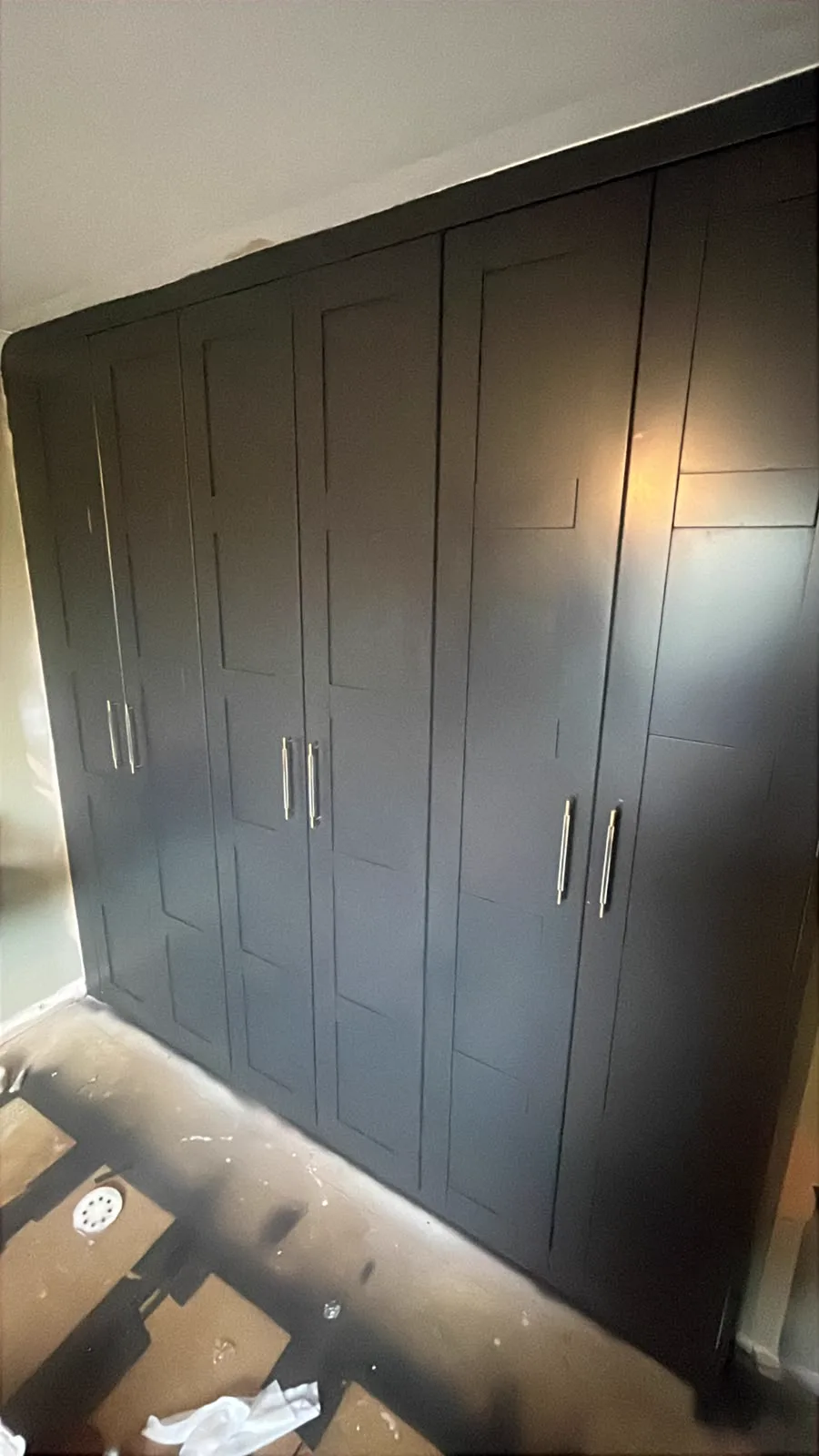 Completed dark floor-to-ceiling wardrobes
